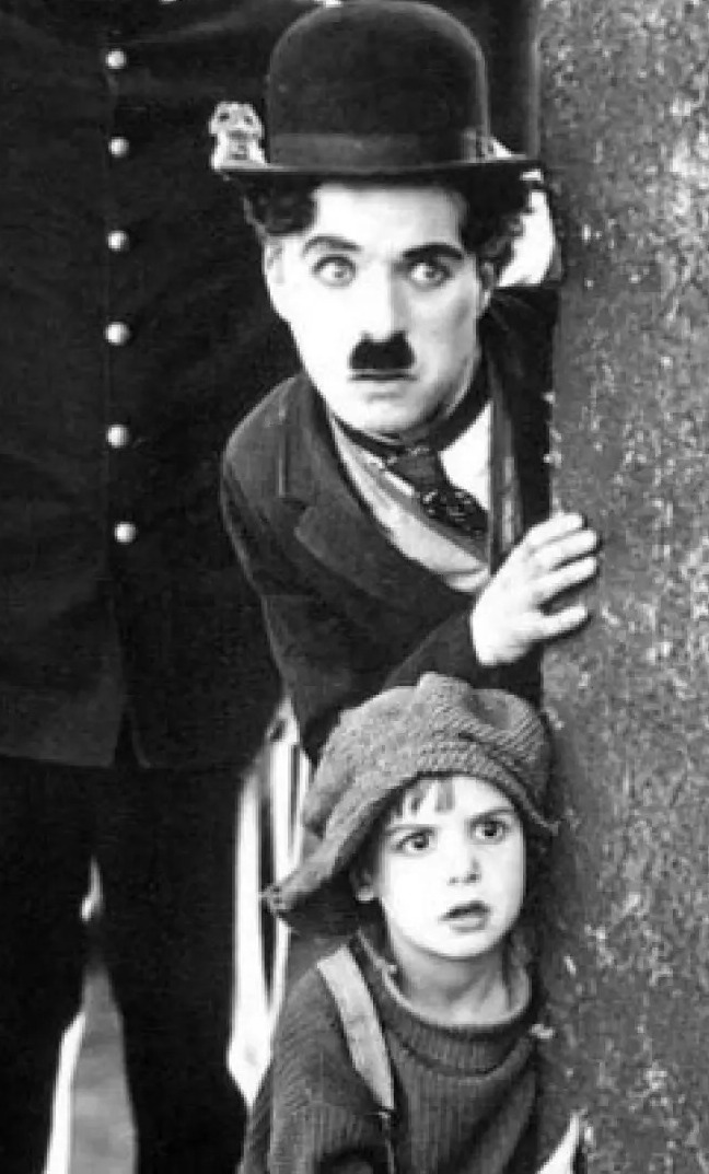 Charlie Chaplin with Jackie Coogan in The Kid.