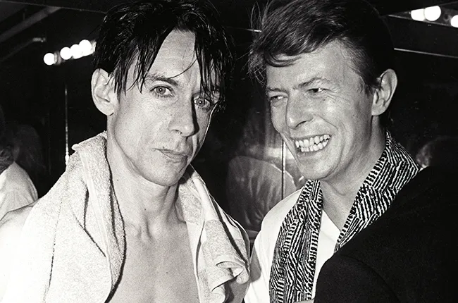 Iggy Pop and David Bowie backstage at the Ritz in New York City, 1986. Photography by L. Busacca/WireImage.