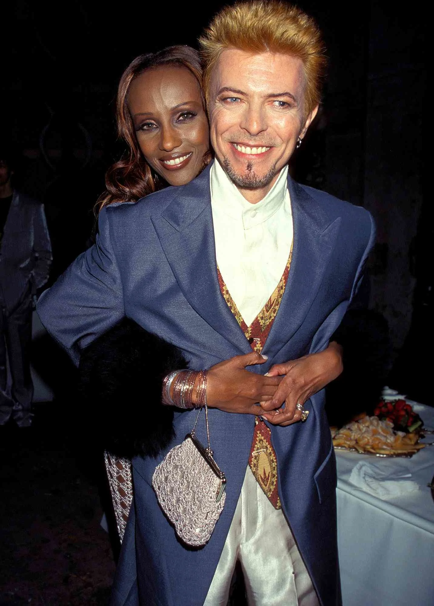 David Bowie being hugged by Iman at his 50th Birthday Concert at Madison Square Garden, January 1997.