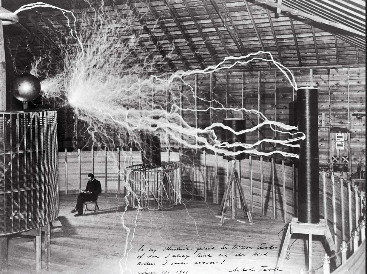 A famous publicity photo of Nikola Tesla in his laboratory in Colorado Springs, Colorado, in December 1899. Tesla posed with his “magnifying transmitter,” which was capable of producing millions of volts of electricity. The discharge shown is 6.7 meters (22 feet) in length.