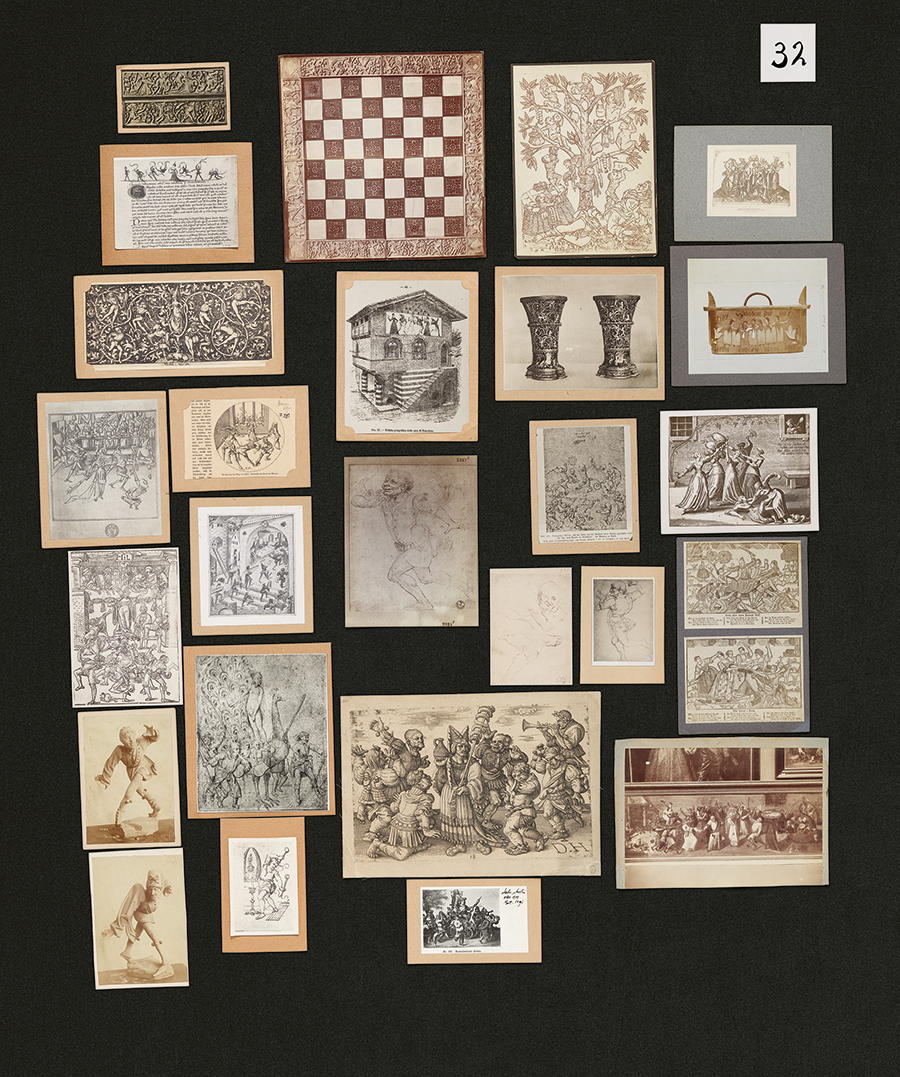 Reconstruction of Panel 32 from Aby Warburg's Mnemosyne Atlas, showing a montage of art historical images on black cloth.